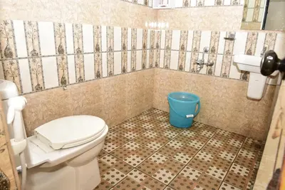 a bathroom with a toilet and a sink at Oceangreen cottage in Kannur