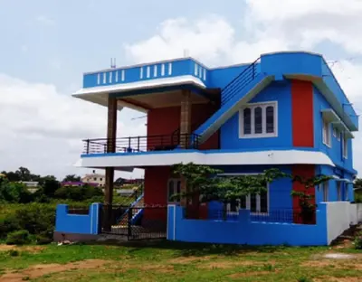 a blue and red house with a balcony at Coorg Dream Land Homestay by StayApart, Kushalnagar in Kushālnagar