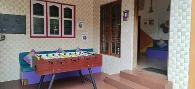 a toy house with a chess game in a room at goSTOPS Coorg in Madikeri