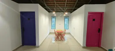 a room with two doors and a table in the middle at goSTOPS Coorg in Madikeri
