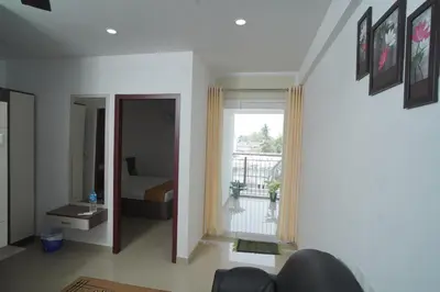 a living room with a bed and a window at SN ROOMS in Perumbavoor