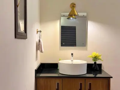 a bathroom with a sink and a mirror at Adrak Mountain Mist Forest Resort in Pulpally