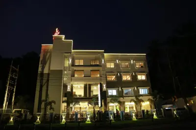 a building with a statue on top of it at night at HOTEL SKY PARADISE in Iritti