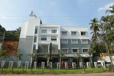 a white building with a statue on top of it at HOTEL SKY PARADISE in Iritti