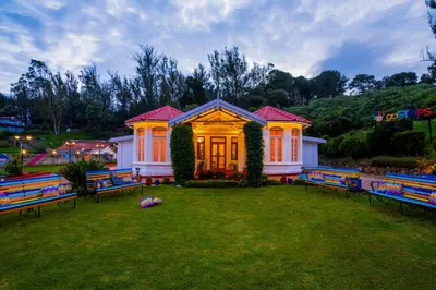 a house with colorful benches in a yard at goSTOPS Ooty in Ooty