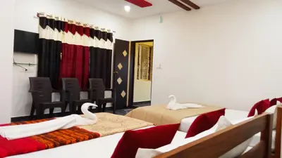 a room with two beds and two swans in it at Leo's Residency Coorg in Kushālnagar
