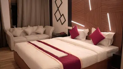 a bedroom with a large bed with red and white pillows at The Lavender Resort Waynad in Vaduvanchal