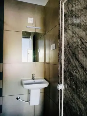 a bathroom with a sink and a mirror at The Lavender Resort Waynad in Vaduvanchal