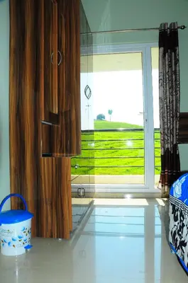 a kitchen with a large window with a view of a field at Rose Garden Enclave for Families & Executives in Ooty