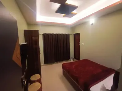 a bedroom with a bed and a ceiling fan at Rose Garden Enclave for Families & Executives in Ooty