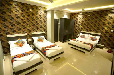 a room with two beds in a room at Geetha Govindham in Guruvāyūr