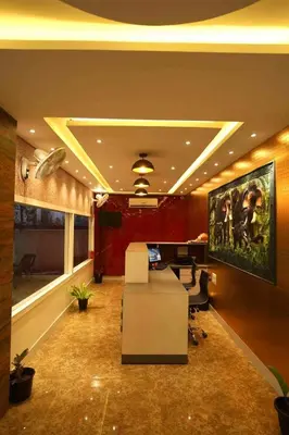 an office with a white desk and a painting on the wall at Geetha Govindham in Guruvāyūr