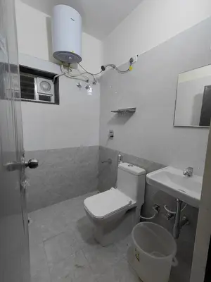 a bathroom with a toilet and a sink at The Jugglers Rest in Mysore