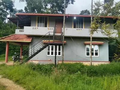 a house with a staircase in front of it at SAMZ ESTATE Stay 3BHK in Madikeri