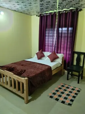 a bedroom with a bed and a window with purple curtains at SAMZ ESTATE Stay 3BHK in Madikeri