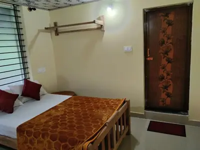 a small room with a bed and a window at SAMZ ESTATE Stay 3BHK in Madikeri