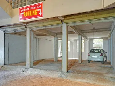 a parking garage with a car parked in it at Marhaba Tourist Home in Kozhikode