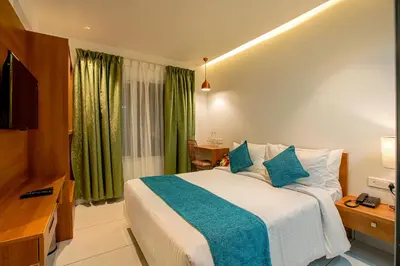 a hotel room with a bed and a television at Harivaram Yuga in Guruvāyūr