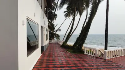 a building on the beach with a red carpet at Willo Stays On the beach Sea view Ocean Hues holiday home in Kannur