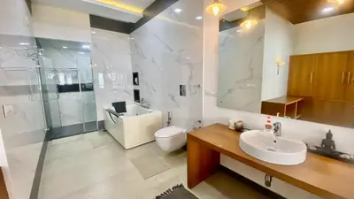 a bathroom with a sink and a toilet and a shower at Willo Stays On the beach Sea view Ocean Hues holiday home in Kannur