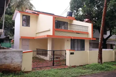 a house with a fence in front of it at Toms Villa along National highway Thrissur at Nadathara in Trichūr