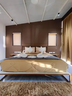 a bedroom with a large gold bed with a rug at Miracle Hotel and Resorts in Kozhikode
