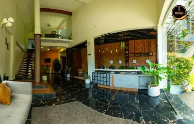 a lobby with a reception counter in a building at Miracle Hotel and Resorts in Kozhikode