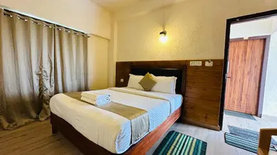 a bedroom with a large bed in a room at Wild Elephant Resort in Kallar Vattiyar