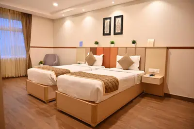 a hotel room with two beds in a room at Soho Boutique Hotel in Mysore