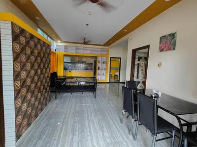 a dining room with a table and chairs in a room at Yellow House in Mysore