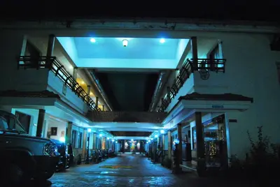 an empty hallway of a building with blue lights at Guruvayoor Resort in Guruvāyūr