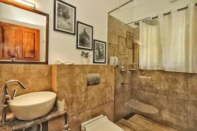 a bathroom with a sink and a shower and a toilet at Vala House - Full Villa in Pallipuram