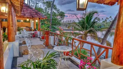 a balcony of a house with a view of the water at Vala House - Full Villa in Pallipuram