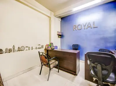 a salon with a chair and a desk and a wall at HOTEL ROYAL PARADISE in Coimbatore