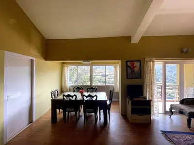 a dining room with a table and chairs at Rustic 3-BR Villa w/ Front & Back Yards in the mountains in Ooty