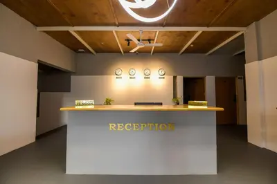 a reception area in a room with a reception counter at Shine Residency in Mysore