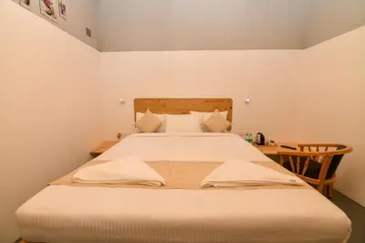 a bedroom with a large bed with a wooden headboard at Shine Residency in Mysore
