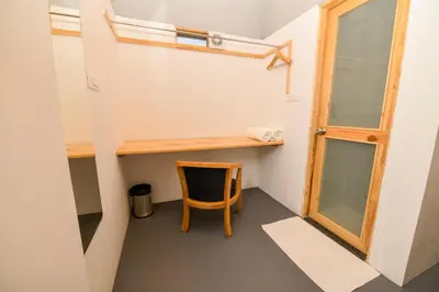 a small room with a wooden desk and a chair at Shine Residency in Mysore
