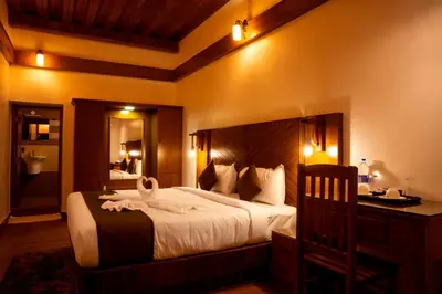 a bedroom with a large bed with towels on it at Stephen's Legacy in Vattavada