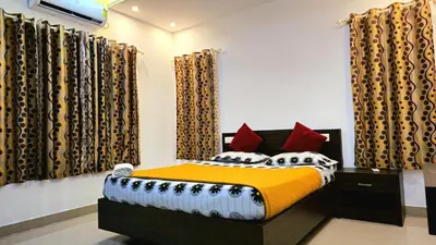 a bedroom with a bed in a room with curtains at RAIN DROPS PREMIUM VILLAS - Athirappilly in Athirappilly