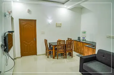 a kitchen and dining room with a table and chairs at RAIN DROPS PREMIUM VILLAS - Athirappilly in Athirappilly