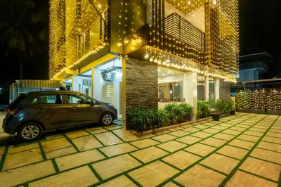 a car parked outside of a building with christmas lights at Daan Regency in Trichūr