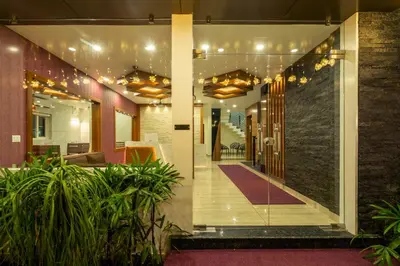 a lobby of a building with plants at Daan Regency in Trichūr