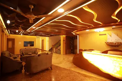 a movie room with chairs and a bar in it at Sree Bharat Residency in Alāndurai