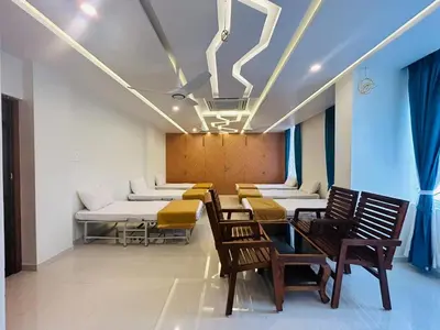a row of chairs and tables in a waiting room at Sree Bharat Residency in Alāndurai