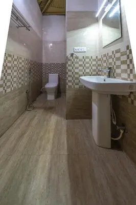 a bathroom with a sink and a toilet at Tranqville Resorts in Ooty