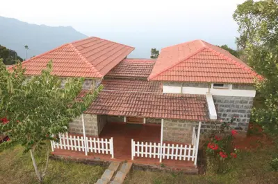 a house with red roofing on top of it at Tranqville Resorts in Ooty