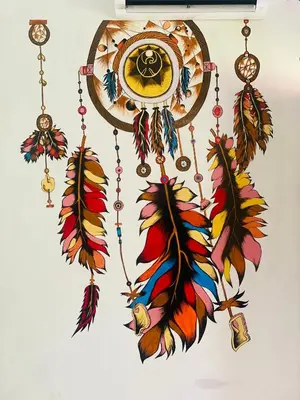 a colorful clock with feathers on a wall at 3 Hills Hostel in Wayanad