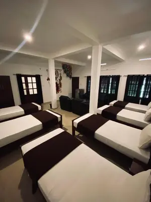a room with a bunch of beds in it at 3 Hills Hostel in Wayanad