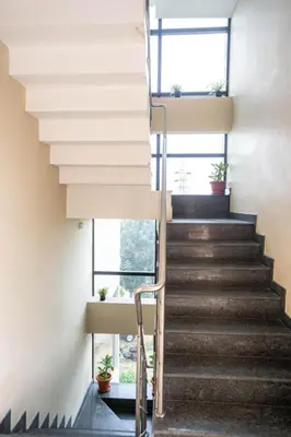 a staircase in a building with potted plants at Samasth Palatial in Mysore
